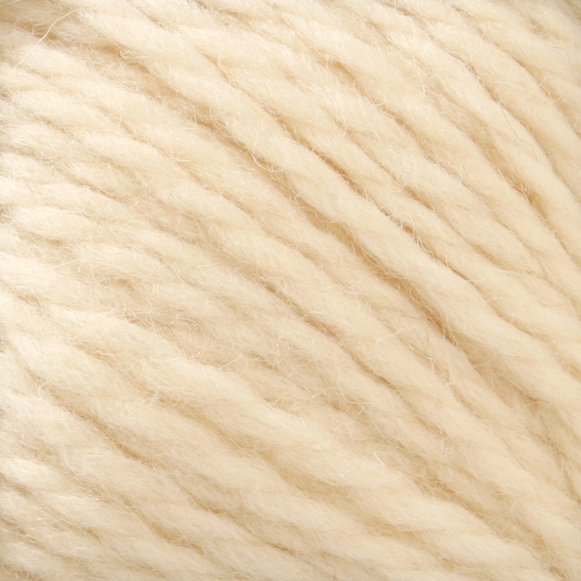 Close-up of cream-colored Cascade Eco and Cascade Eco Plus Wool Yarn fibers intertwined in a soft, fluffy texture. Made from Peruvian Highland wool by Cascade Yarns, the strands are thick and loosely twisted, creating a cozy and warm appearance.