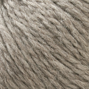 Close-up image of Cascade Eco and Cascade Eco Plus Wool Yarn by Cascade Yarns in beige or light brown, showcasing the texture and fibers intertwined in a slightly rough pattern. The thick strands, made of Peruvian Highland wool, appear soft and are perfect for knitting or crafting projects.