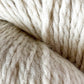 Close-up image of thick, off-white Cascade Eco and Cascade Eco Plus wool yarn from Cascade Yarns, showcasing visible fibers and a soft, fluffy texture. The tightly twisted strands create a cozy and warm appearance.